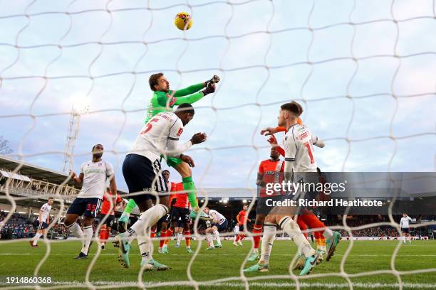 Tim Krul of Luton Town punches the ball towards his own goal whilst under pressure from Ricardo Santos of Bolton Wanderers during the Emirates FA Cup...