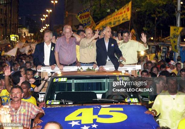 Jose Serra, Brazilian presidential candidate of the Social Democratic Party, greets his followers while riding a truck with vice president Marcos...