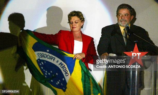 Brazilian Workers' Party presidential candidate Luiz Inacio Lula da Silva, accompanied by his wife Marisa, speaks 21 October during a meeting with...