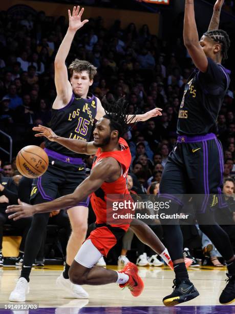 Los Angeles, CA, Tuesday, January 9, 2024 - Toronto Raptors guard Immanuel Quickley is fouled by Los Angeles Lakers forward Cam Reddish , right in...