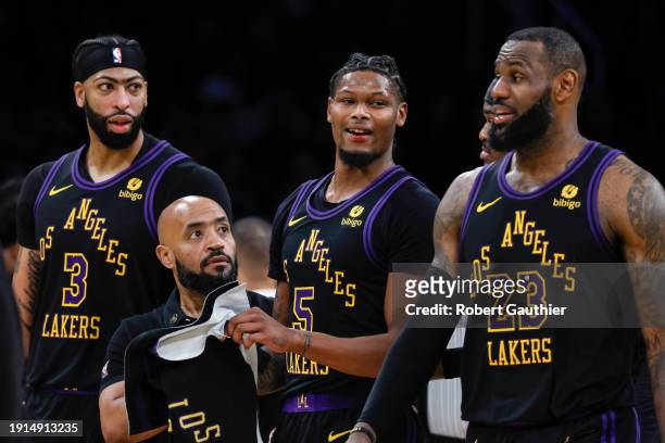 Los Angeles, CA, Tuesday, January 9, 2024 - Los Angeles Lakers forward Cam Reddish is escorted by teammates after sustaining a bloody lip from the...