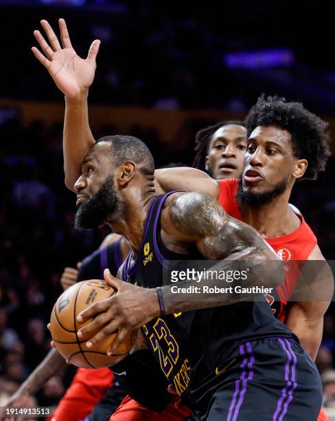 Los Angeles, CA, Tuesday, January 9, 2024 - Los Angeles Lakers forward LeBron James takes a blow from Toronto Raptors forward Thaddeus Young while...