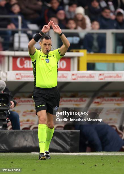 Referee Maurizio Mariani gestures to have checked with the VAR after showing a yellow card to Pasquale Mazzocchi of SSC Napoli for a foul on...