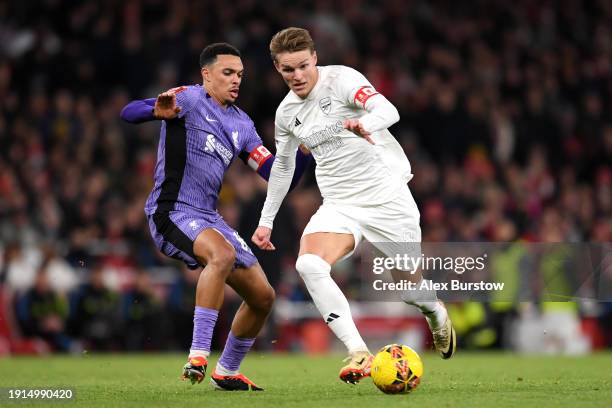 Martin Odegaard of Arsenal runs with the ball whilst under pressure from Trent Alexander-Arnold of Liverpool during the Emirates FA Cup Third Round...