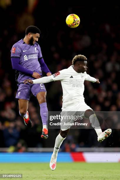 Joe Gomez of Liverpool wins a header whilst under pressure from Bukayo Saka of Arsenal during the Emirates FA Cup Third Round match between Arsenal...