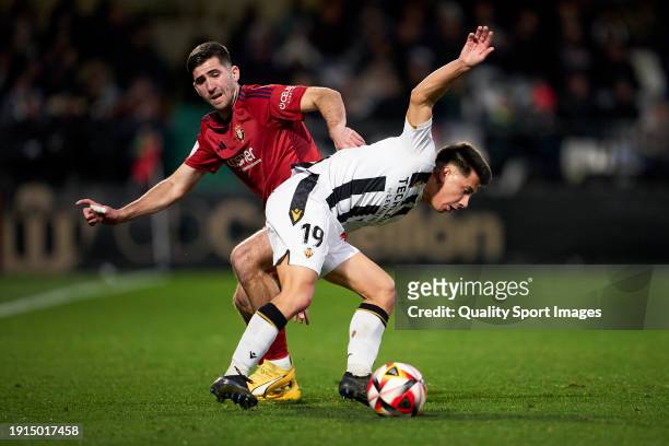 Jesus Areso of CA Osasuna competes for the ball with Dani Villahermosa of CD Castellon during the Copa del Rey Round of 32 match between CD Castellon...