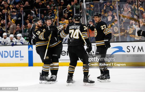 Trent Frederic of the Boston Bruins celebrates with his teammates Kevin Shattenkirk, Jake DeBrusk and Hampus Lindholm after he scored against the...