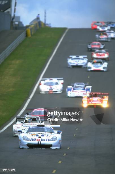 The Porsche AG, Porsche 911 GT1 driven by Hans Stuck of Denmark, Thierry Boutsen of Belgium and Bob Wolek of France leads the field during the Le...