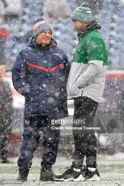 New England Patriots head coach Bill Belichick and Aaron Rodgers of the New York Jets speak before a game at Gillette Stadium on January 07, 2024 in...