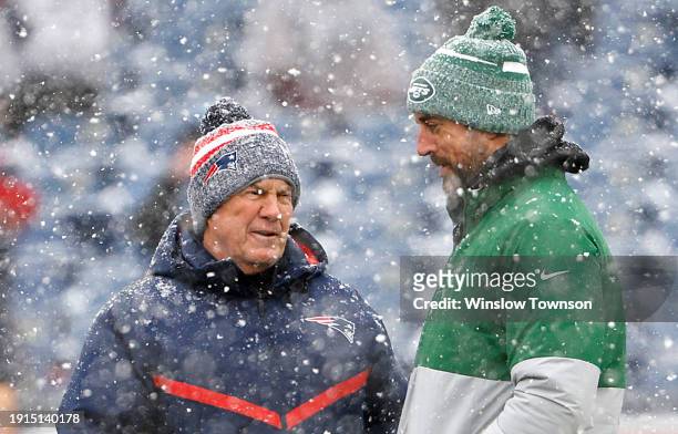 New England Patriots head coach Bill Belichick and Aaron Rodgers of the New York Jets speak before a game at Gillette Stadium on January 07, 2024 in...