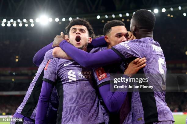 Luis Diaz and Trent Alexander-Arnold of Liverpool celebrate with teammates their team's first goal, an own goal scored by Jakub Kiwior of Arsenal...