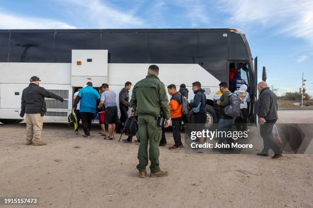 Immigrants file into a U.S. Customs and Border Protection bus after crossing the U.S.-Mexico border on January 07, 2024 in Eagle Pass, Texas....