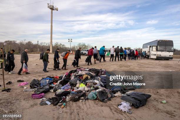 Immigrants file into a U.S. Customs and Border Protection bus after crossing the U.S.-Mexico border on January 07, 2024 in Eagle Pass, Texas....