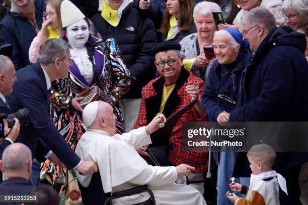 Pope Francis is posing with participants during his weekly general audience in the Paul VI Audience Hall in Vatican City, on January 10, 2024.