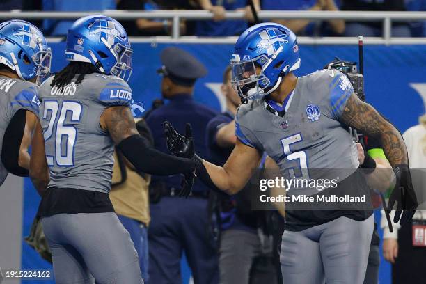 Jahmyr Gibbs of the Detroit Lions celebrates after a touchdown with David Montgomery during the first quarter in the game against the Minnesota...