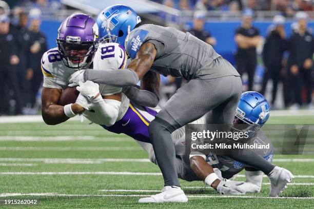 Justin Jefferson of the Minnesota Vikings is tackled by Cameron Sutton and Kerby Joseph of the Detroit Lions during the second quarter at Ford Field...