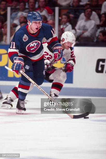 New York Islander's defenseman, Darius Kasparaitis, races the puck out of his zone during the game against the NJ Devils at the Meadowlands Arena...