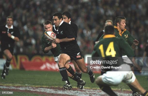 Frank Bunce of New Zealand charges forward to score a try during the Tri-Nations match at Ellis Park in Johannesburg, South Africa. The All Blacks...