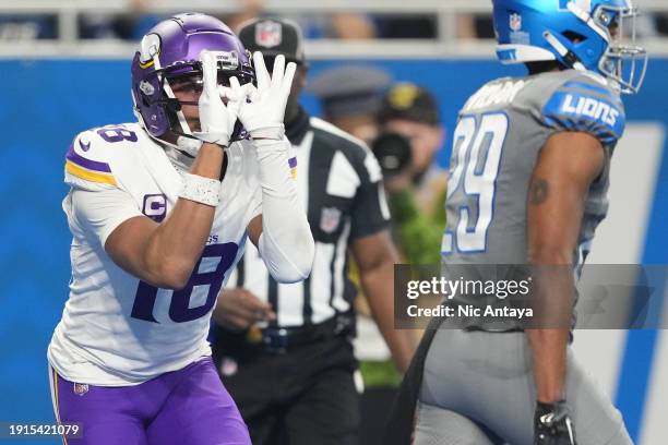 Justin Jefferson of the Minnesota Vikings celebrates after a touchdown while defended by Kindle Vildor of the Detroit Lions during the third quarter...