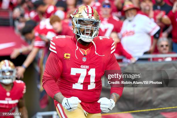 Offensive tackle Trent Williams of the San Francisco 49ers celebrates with fans as he leads the San Francisco 49ers offensive players onto the field...