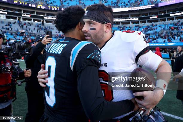 Bryce Young of the Carolina Panthers and Baker Mayfield of the Tampa Bay Buccaneers embrace after the game at Bank of America Stadium on January 07,...