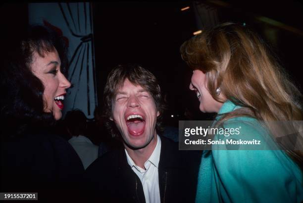 View of, from left, fashion model Pat Cleveland, and couple British Rock singer Mick Jagger & American model Jerry Hall, as they attend a book party...
