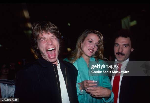 View of, from left, couple British Rock singer Mick Jagger & American model Jerry Hall, and Puerto Rican fashion illustrator Antonio Lopez attend a...