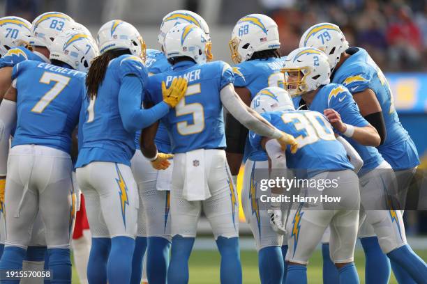 Easton Stick of the Los Angeles Chargers leads the huddle in the first half during a game against the Kansas City Chiefs at SoFi Stadium on January...
