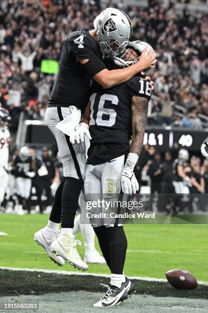 Jakobi Meyers of the Las Vegas Raiders celebrates after a touchdown with Aidan O'Connell during the first quarter in the game against the Denver...