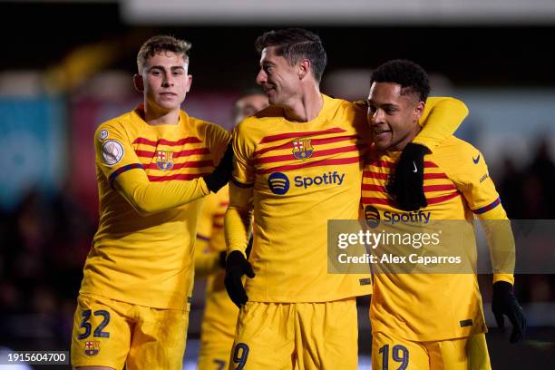 Robert Lewandowski of FC Barcelona celebrates with his teammates Fermin Lopez and Vitor Roque after scoring their team's third goal with a penalty...