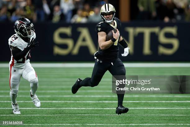 Taysom Hill of the New Orleans Saints runs the ball against Clark Phillips III of the Atlanta Falcons during a game at Caesars Superdome on January...