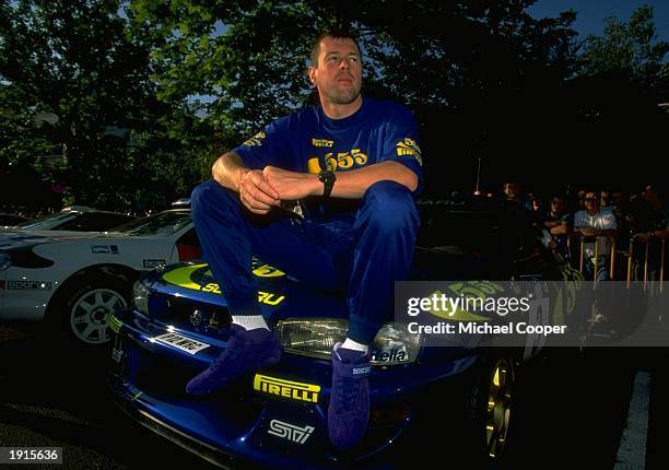 Colin McRae of Scotland sits on the bonnet of his Subaru Impreza in the Acropolis Rally during the FIA World Rally Championships in Athens, Greece. \...
