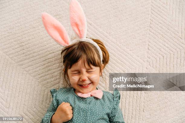 cheerful little girl  with face painting as a easer bunny - happy easter stock pictures, royalty-free photos & images