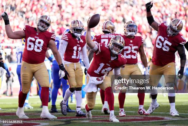 Sam Darnold of the San Francisco 49ers celebrates with teammates after a touchdown run in the second quarter during a game against the Los Angeles...