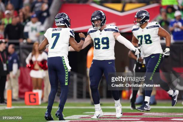 Geno Smith and Will Dissly of the Seattle Seahawks celebrate after a touchdown during the second quarter against the Arizona Cardinals at State Farm...