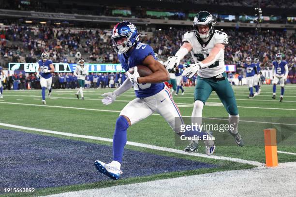 Darius Slayton of the New York Giants scores a touchdown while defended by Reed Blankenship of the Philadelphia Eagles during the second quarter at...