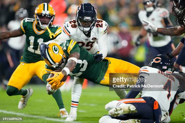 Dontayvion Wicks of the Green Bay Packers scores a touchdown during the third quarter in the game against the Chicago Bears at Lambeau Field on...