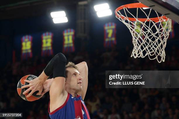 Barcelona's Czech center Jan Vesely jumps to score a dunk during the Euroleague round 20 basketball match between FC Barcelona and Olympiakos Piraeus...