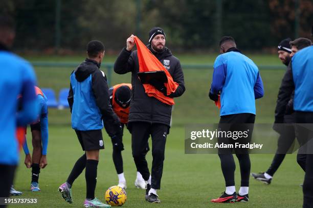 Damia Abella Statistical Analyst of West Bromwich Albion hands out training bibs during a first team training session at West Bromwich Albion...