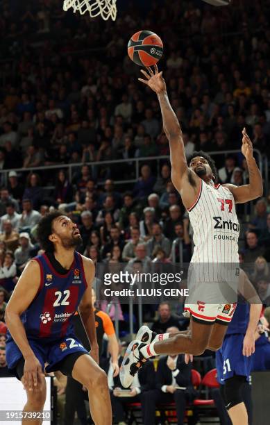 Olympiacos Piraeus' American guard Shaquielle McKissic puts up a shot over Barcelona's US forward Jabari Parker during the Euroleague round 20...