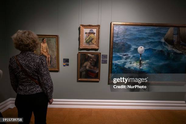 Person is looking at some paintings in the exhibition of artist Christian Krohg at the Rasmus Meyer Museum in Bergen, Norway, on November 6, 2023....