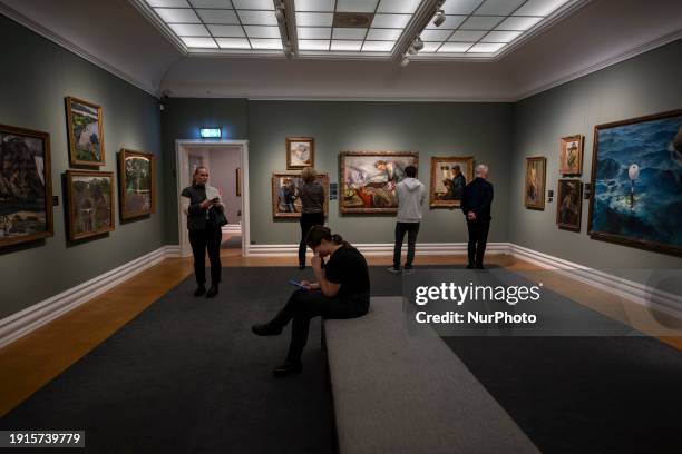 Several people are looking at paintings in the exhibition of artist Christian Krohg at the Rasmus Meyer Museum in Bergen, Norway, on November 6,...