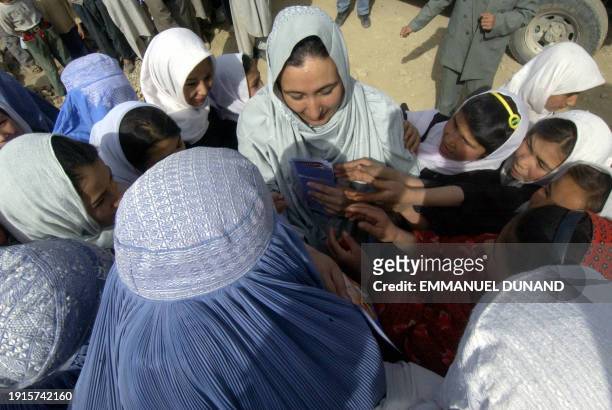 Afghan presidential candidate Masooda Jalal distributes electoral campaign leaflets to woman villagers and schoolgirls in Lolang, some 100 kilometres...