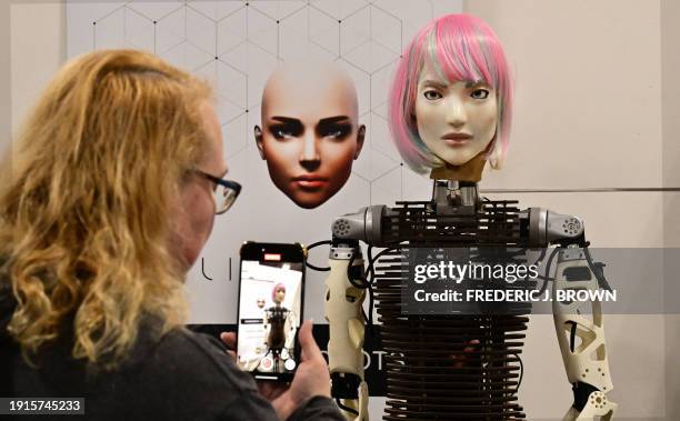 Woman photographs a Humanoid Robot from AI Life with Bio-Inspired communicative AI, on display at the Consumer Electronics Show in Las Vegas, Nevada...