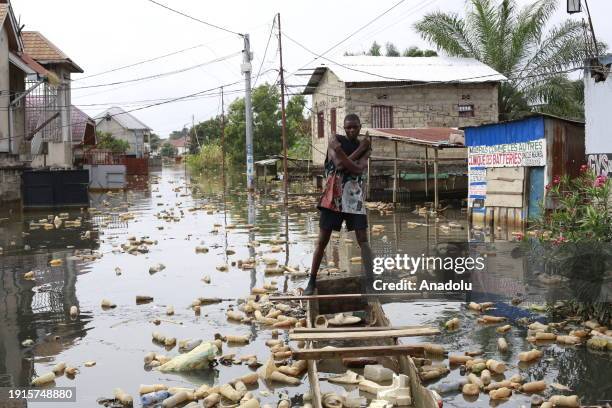 Citizens move with boats made of wood on the flooded streets after heavy rain in Kinsuka region, north of Kinshasa, Democratic Republic of the Congo...