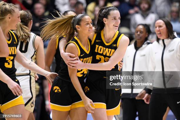 Iowa Hawkeyes Guard Caitlin Clark embraces Iowa Hawkeyes Guard Gabbie Marshall after a play during the women's college basketball game between the...