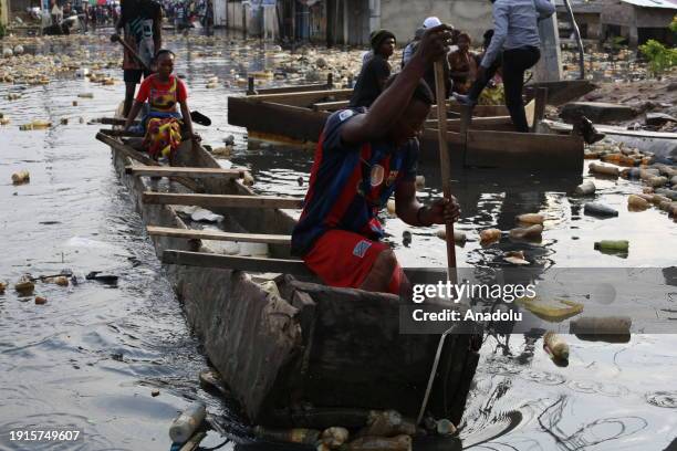 Citizens move with boats made of wood on the flooded streets after heavy rain in Kinsuka region, north of Kinshasa, Democratic Republic of the Congo...