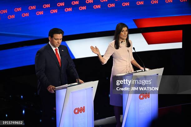 Former US Ambassador to the UN Nikki Haley speaks as Florida Governor Ron DeSantis looks down during the fifth Republican presidential primary debate...