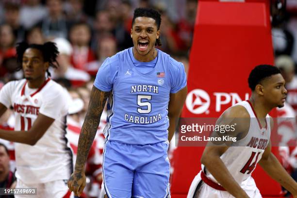 Armando Bacot of the North Carolina Tar Heels reacts following a dunk during the second half against the NC State Wolfpack at PNC Arena on January...