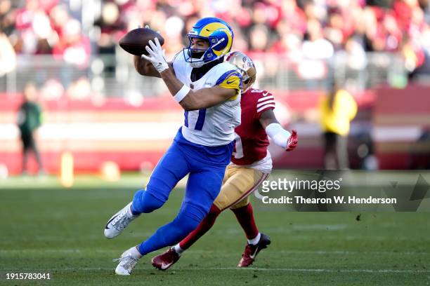Puka Nacua of the Los Angeles Rams catches a pass breaking the "total receiving yards in a season for a rookie" record against Samuel Womack III of...
